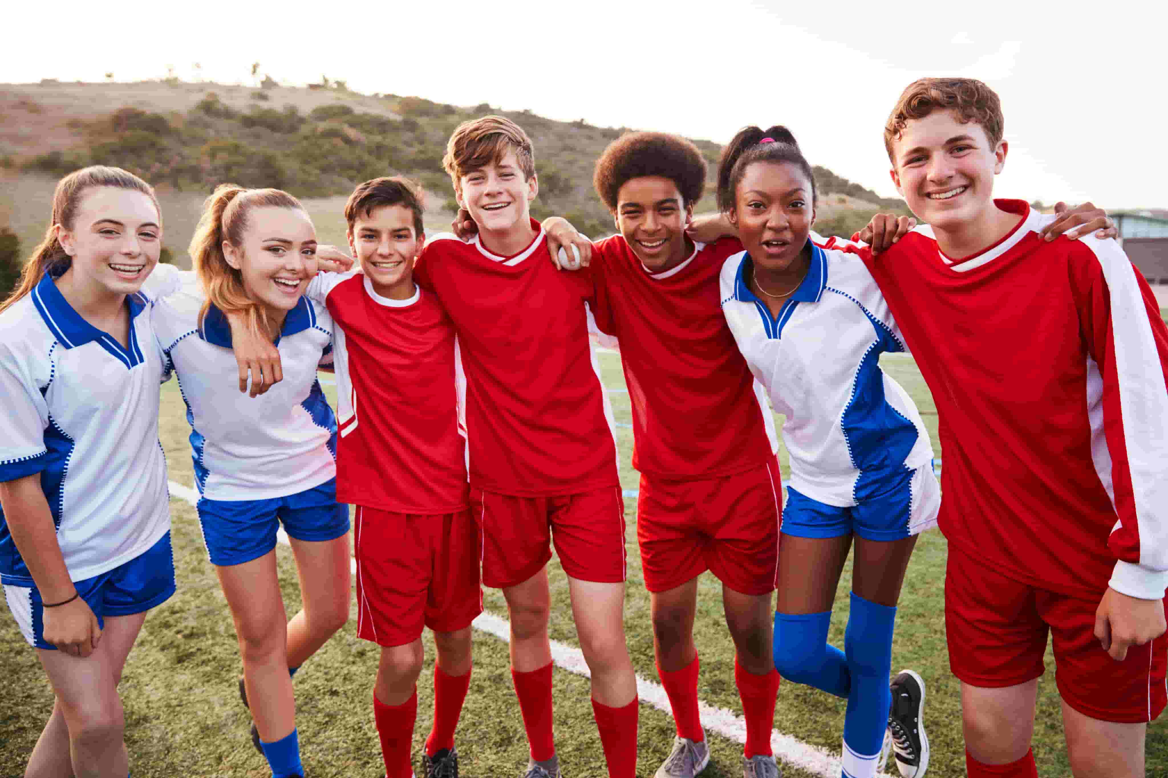Students smiling together playing Soccer